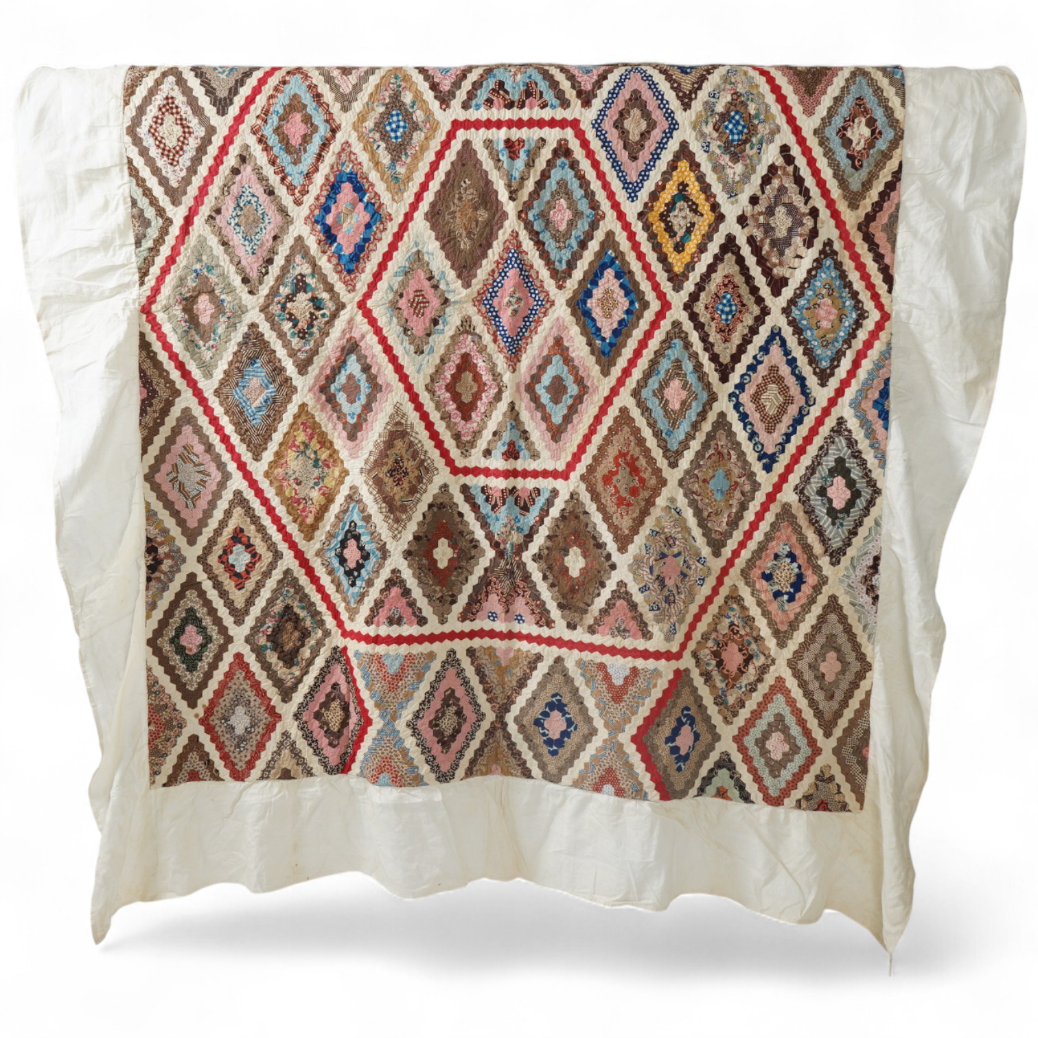 An ornate 19th century Log Cabin patchwork, made mostly from printed dress cottons from 1850-1900. 195cm long x 157cm wide., Condition - The colours are still bright and cotton strong. The patchwork backing and the cream